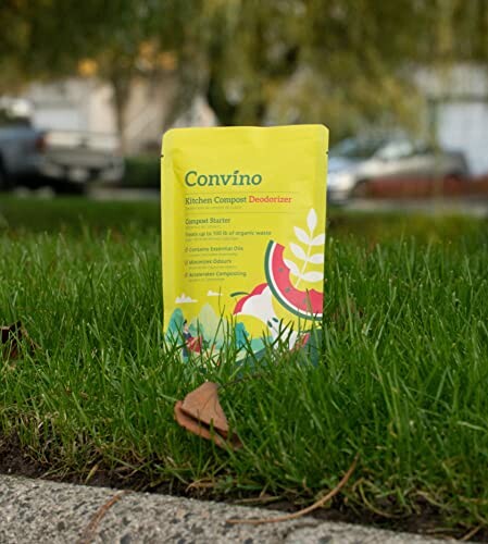 Compost deodorizer pouch standing on grass.