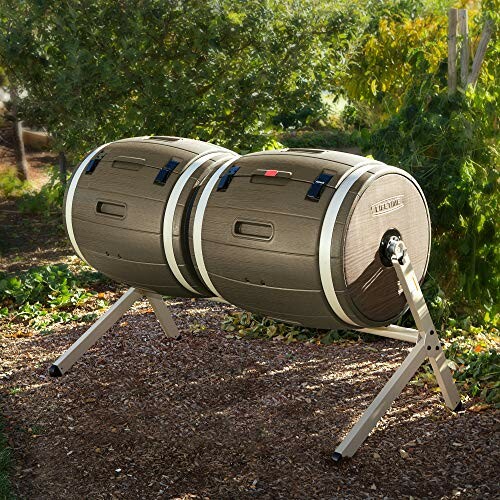 Dual chamber compost tumbler in a garden setting