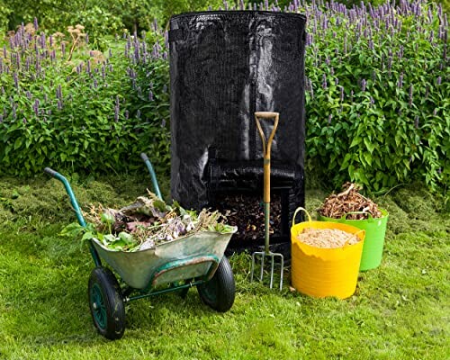 Compost bin with gardening tools and materials in a garden.