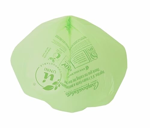 Green biodegradable bag with printed text.