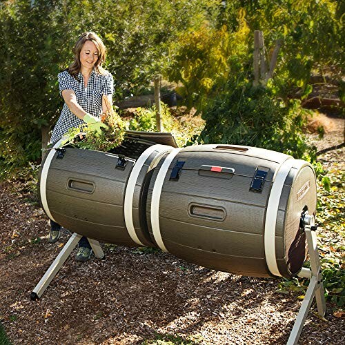 Woman adding leaves to a compost tumbler outdoors